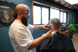 Skilled barber Sheldon providing precision haircut at Cache Cuts Logan Utah barbershop — Expert barber Sheldon delivering VIP haircut service in our luxury Logan barbershop